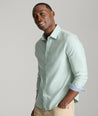 Model is wearing UNTUCKit Burke shirt in basil.