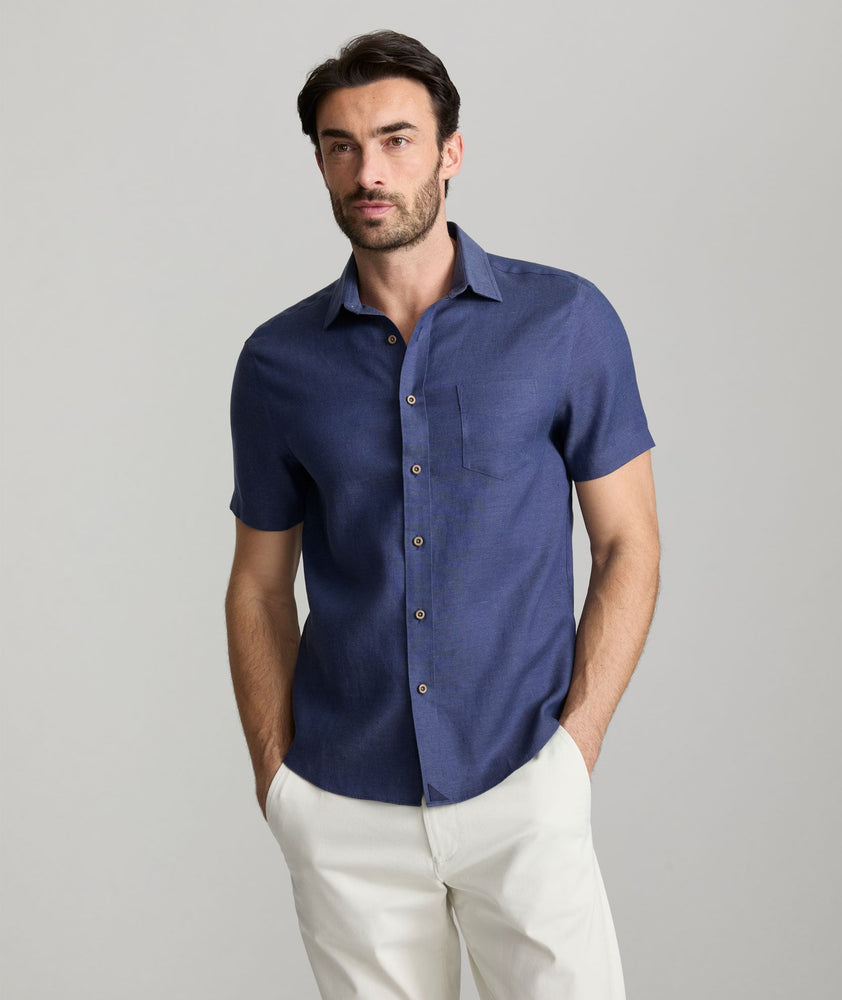 Model wearing an UNTUCKit Navy Wrinkle-Resistant Linen Short Sleeve Cameron Shirt.