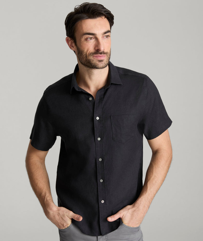 Model wearing an UNTUCKit Black Wrinkle-Resistant Linen Short Sleeve Cameron Shirt.