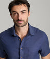 Model wearing an UNTUCKit Navy Wrinkle-Resistant Linen Short Sleeve Cameron Shirt