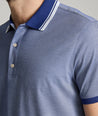 Model is wearing UNTUCKit Day Performance Polo in  Blue Depth.