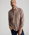 Model is wearing UNTUCKit Flannel Hemsworth Shirt in brown.