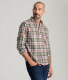 Model is wearing UNTUCKit Larson flannel in green grounded peach plaid. 