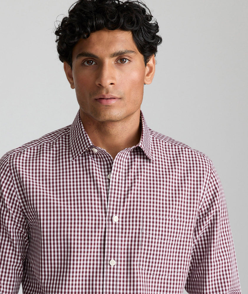 Model is wearing UNTUCKit Lawerence in maroon gingham. 