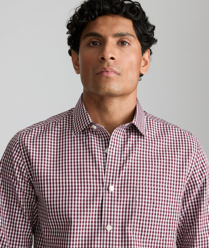 Model is wearing UNTUCKit Lawerence in maroon gingham. 