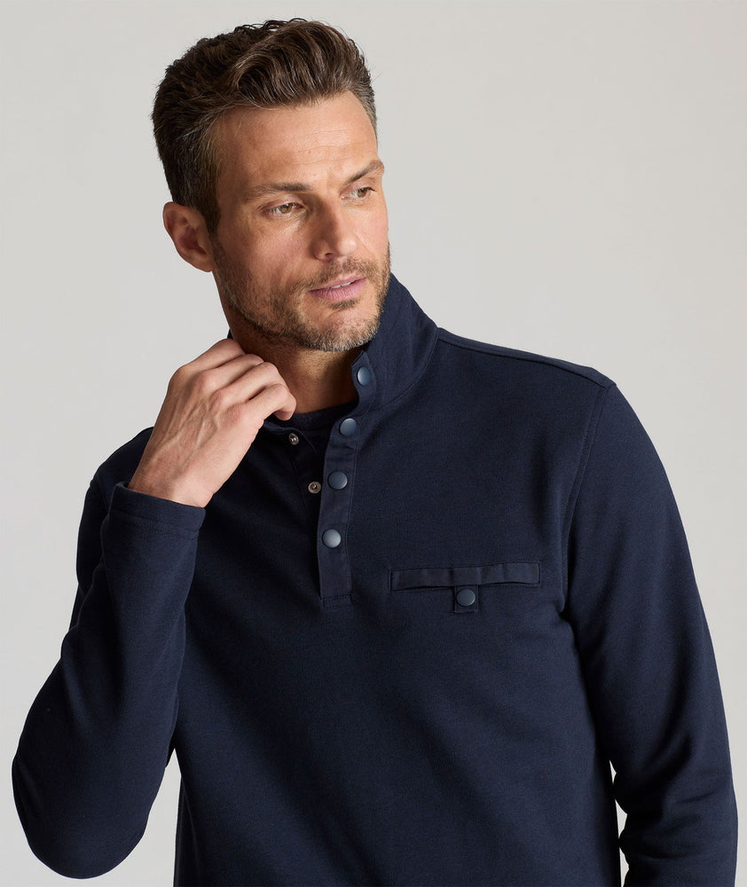 Model is wearing UNTUCKit Parkson quarter-zip sweatshirt in navy.