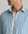 Model is wearing UNTUCKit Starling performance shirt in blue green.