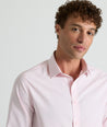 Model is wearing UNTUCKit Travels shirt in tiny pink gingham. 