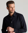 Model is wearing UNTUCKit Wrinkle-Free Veneto Shirt in black.