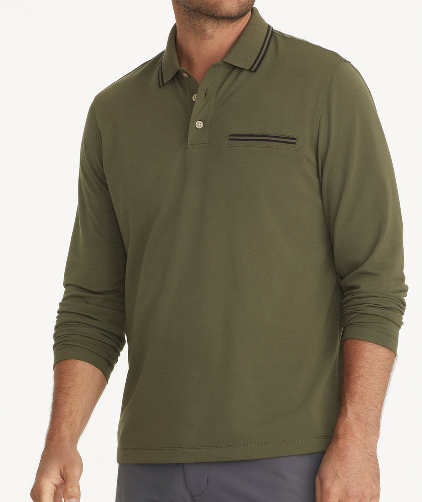 Model is wearing UNTUCKit Ceasar long sleeve polo in ivy green. 