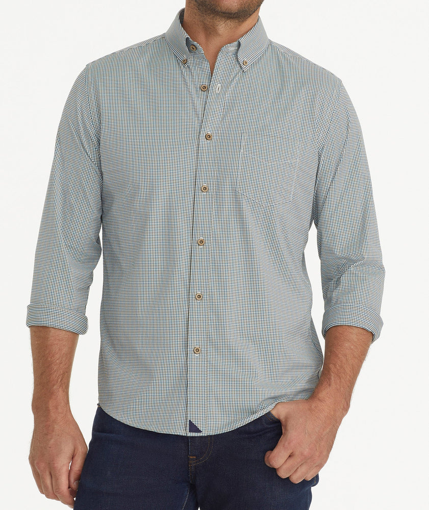 Model is wearing UNTUCKit Wrinkle-Free Performance Rowan-Brown Shirt in Small Teal & Olive Check.