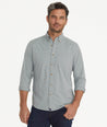 Model is wearing UNTUCKit Wrinkle-Free Performance Rowan-Brown Shirt in Small Teal & Olive Check.