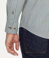 Model is wearing UNTUCKit Wrinkle-Free Performance Rowan-Brown Shirt in Small Teal & Olive Check.