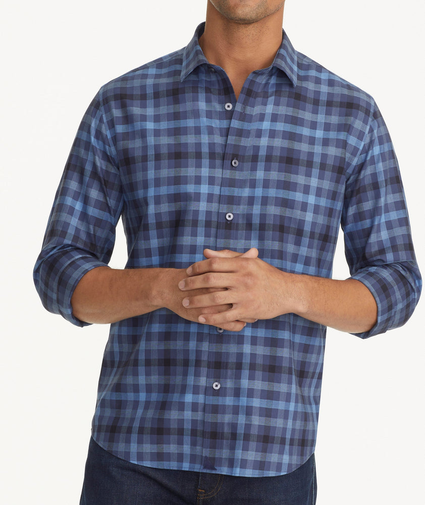 Model is wearing UNTUCKit Wrinkle-Free Walton Shirt in Blue & Black Check.