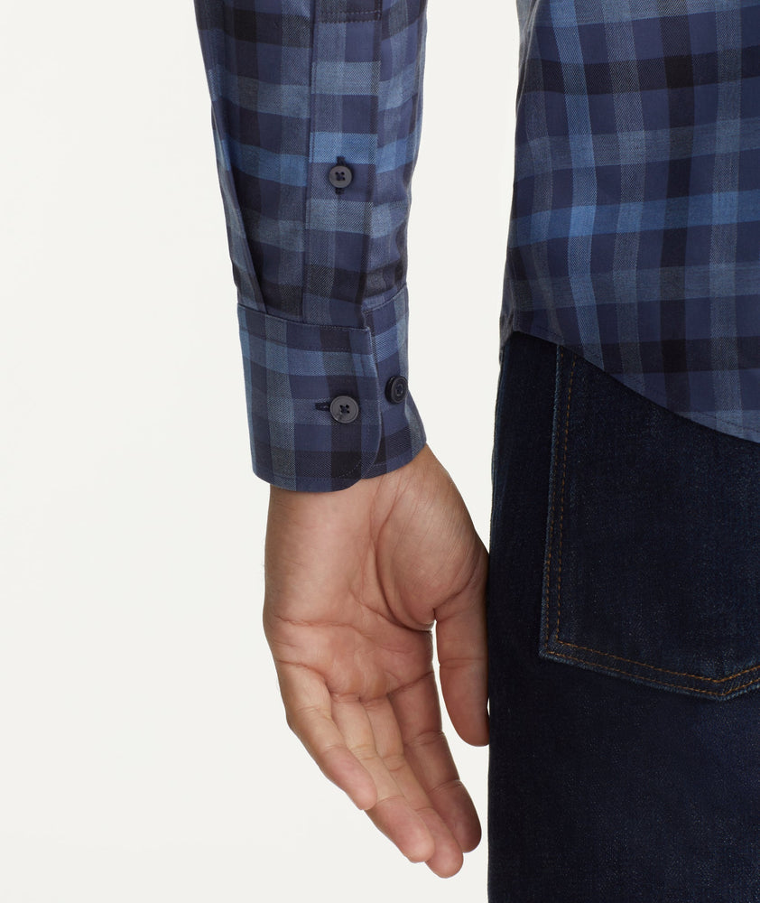 Model is wearing UNTUCKit Wrinkle-Free Walton Shirt in Blue & Black Check.